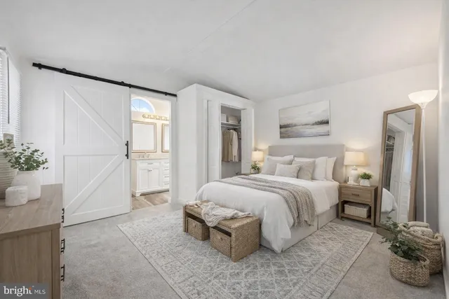 a spacious bedroom with a bed and a cabinets