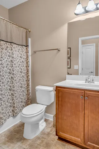 a bathroom with a toilet a sink and a shower