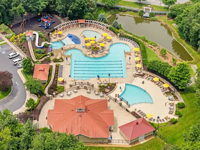 an aerial view of a house with a swimming pool patio and outdoor seating