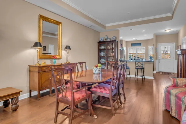 a dining room with furniture and wooden floor