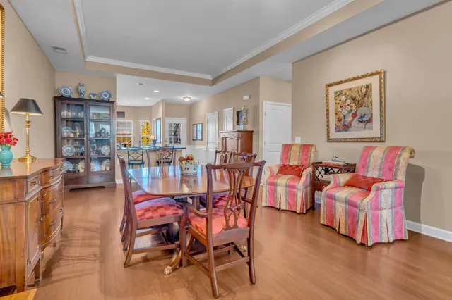 a dining room with furniture and wooden floor