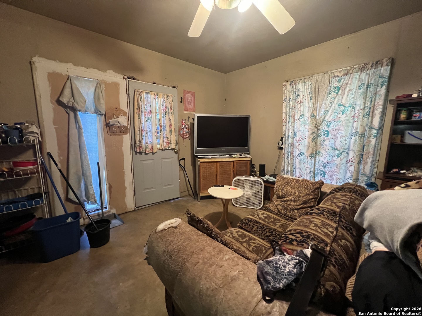 1338 Merida Street San Antonio, TX 78207 - Photo 13 of 16 a living room with furniture a flat screen tv and a window