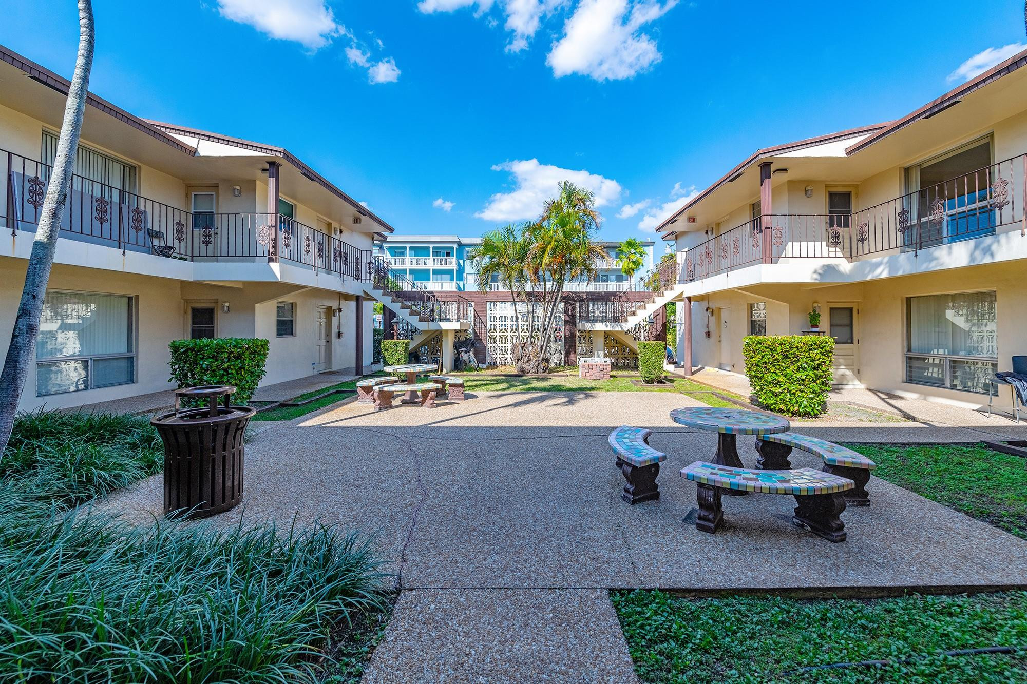 3500 Jackson Street, Unit 105 Hollywood, FL 33021 - Photo 3 of 14 a view of a patio with table and chairs and potted plants