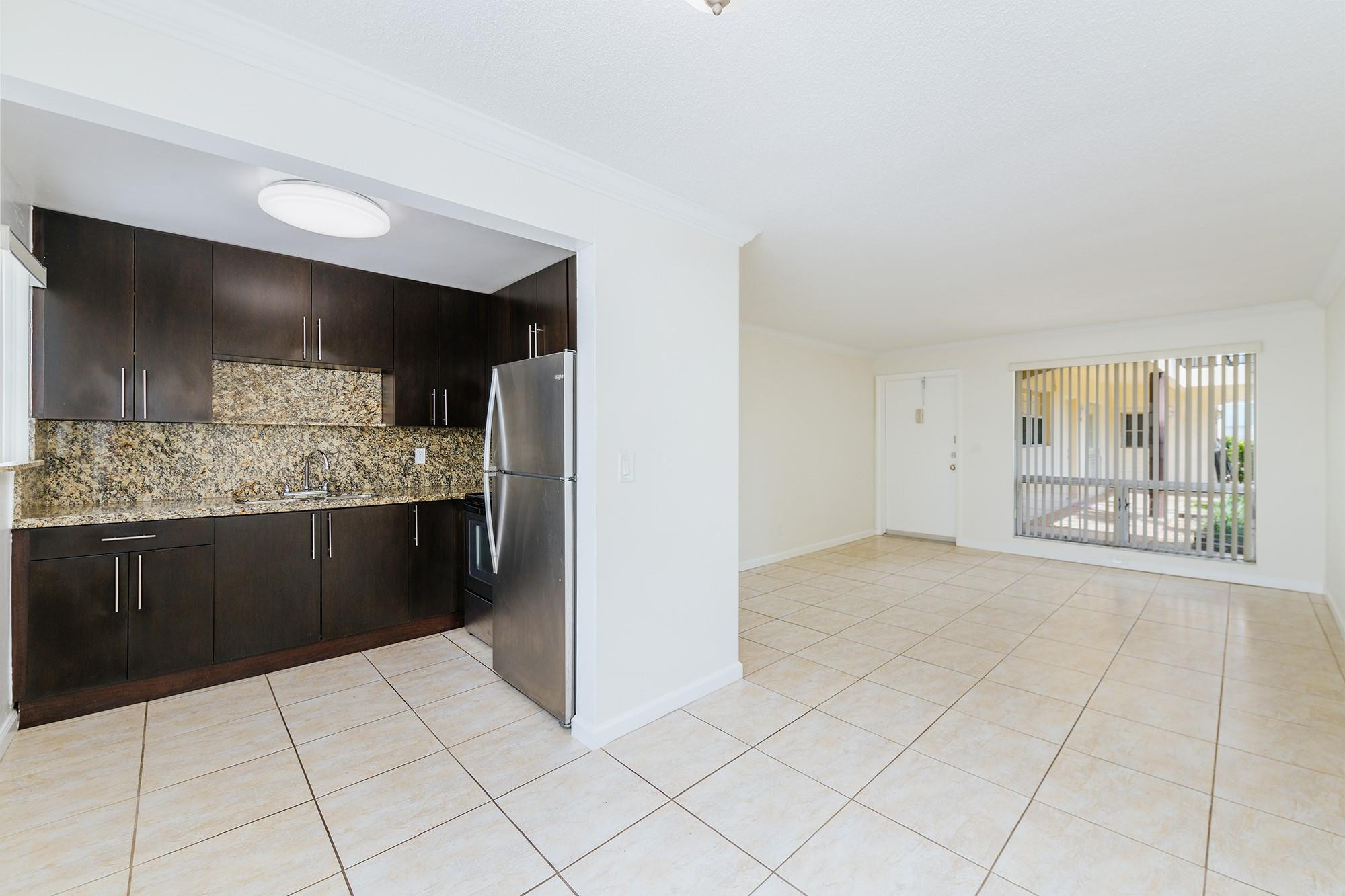 3500 Jackson Street, Unit 105 Hollywood, FL 33021 - Photo 9 of 14 a large white kitchen with a sink and cabinets