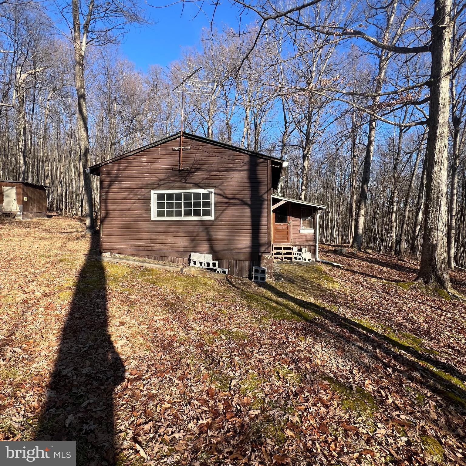 5840 Tram Road Spruce Creek, PA 16683 - Photo 1 of 6 a front view of a house with a yard