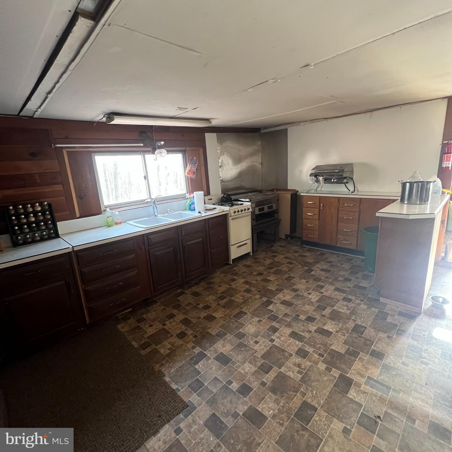 5840 Tram Road Spruce Creek, PA 16683 - Photo 4 of 6 a kitchen with stainless steel appliances a sink stove and cabinets
