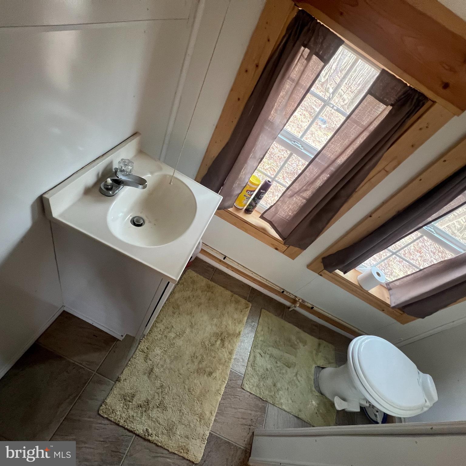 5840 Tram Road Spruce Creek, PA 16683 - Photo 6 of 6 a bathroom with a toilet sink and mirror