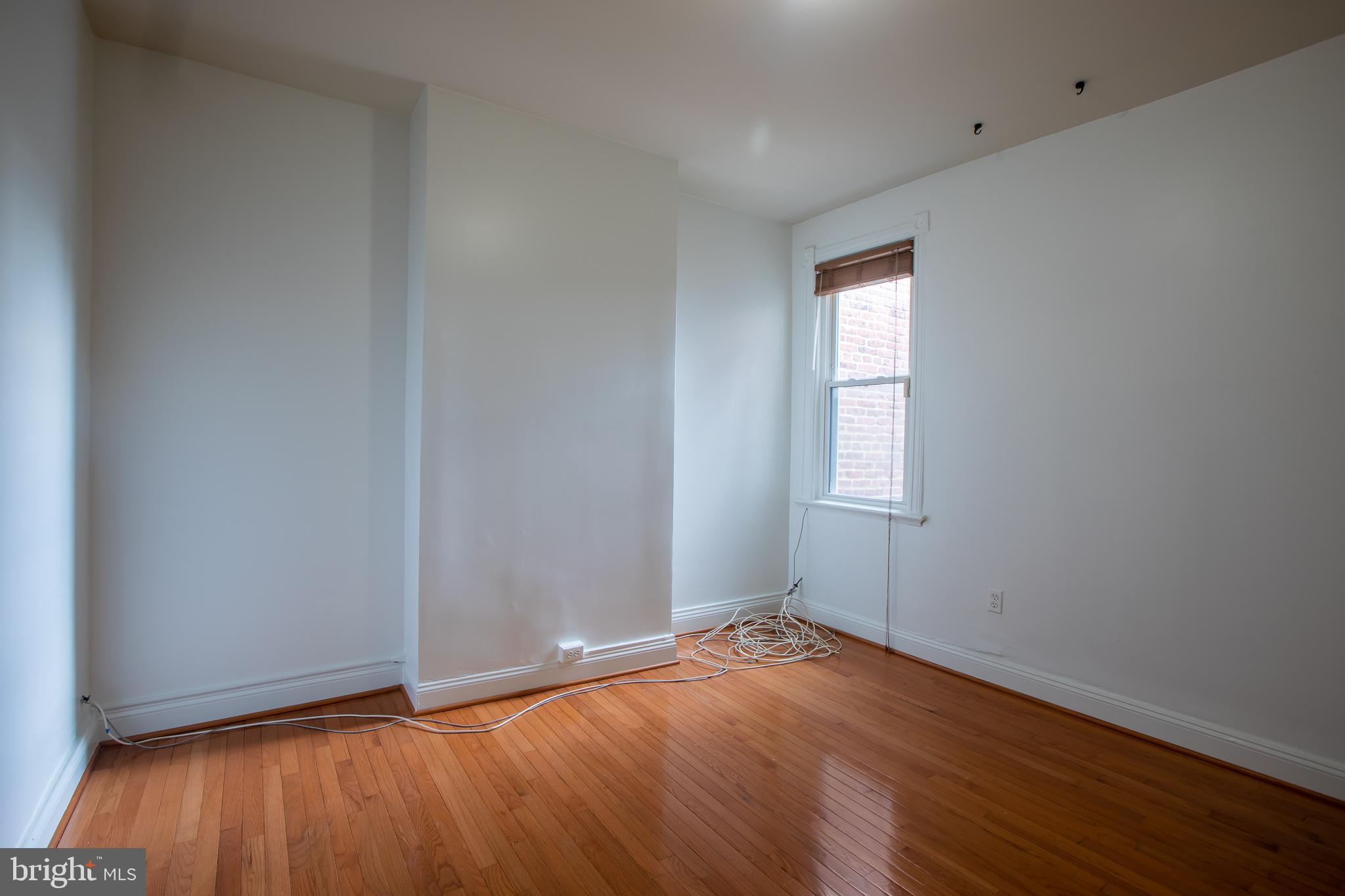 1117 I Street Northeast Washington, DC 20002 - Photo 11 of 23 an empty room with wooden floor and windows
