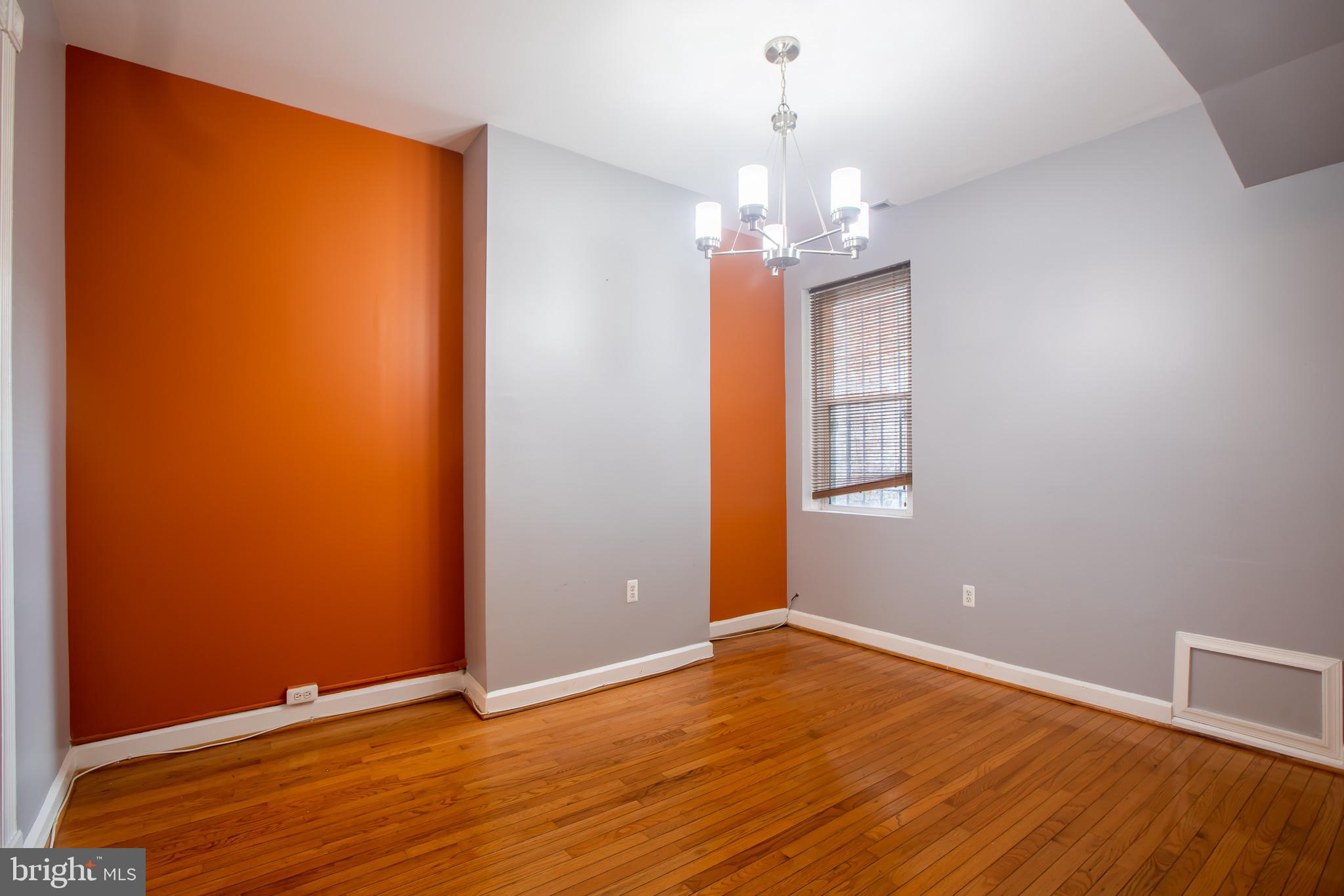 1117 I Street Northeast Washington, DC 20002 - Photo 15 of 23 an empty room with wooden floor chandelier and windows