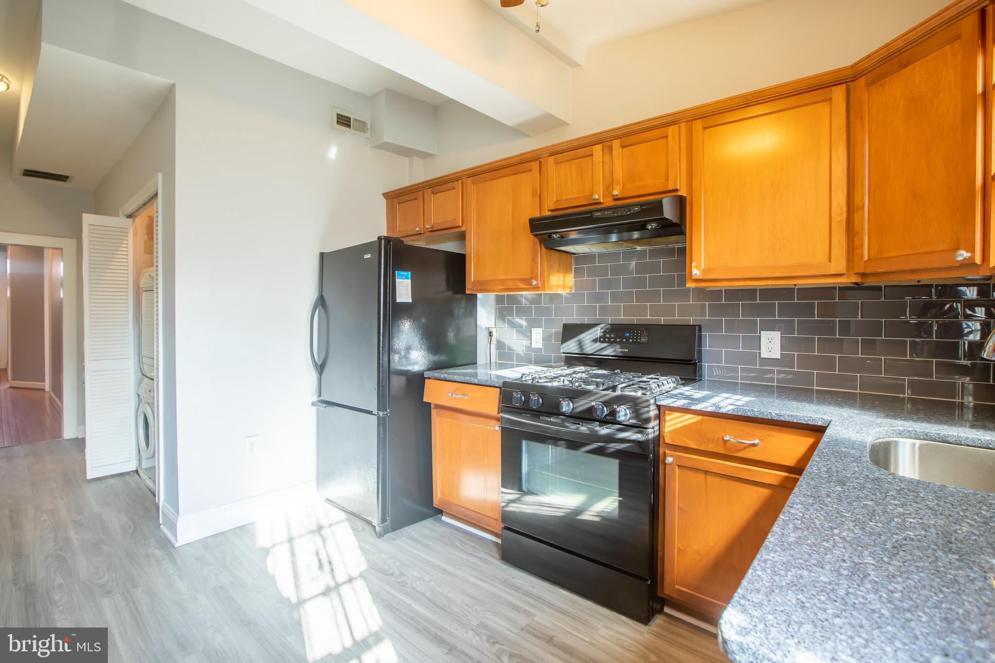 1117 I Street Northeast Washington, DC 20002 - Photo 17 of 23 a kitchen with stainless steel appliances granite countertop a stove a refrigerator and a sink