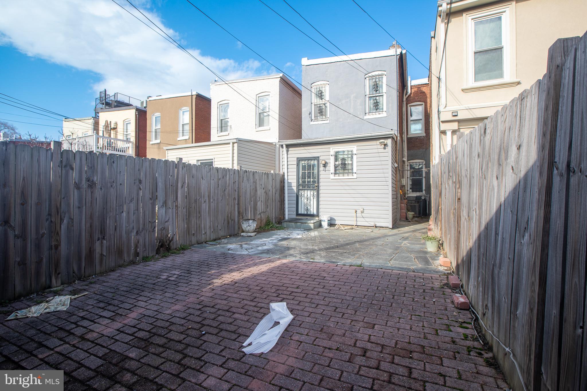1117 I Street Northeast Washington, DC 20002 - Photo 22 of 23 a view of a grey house with a yard