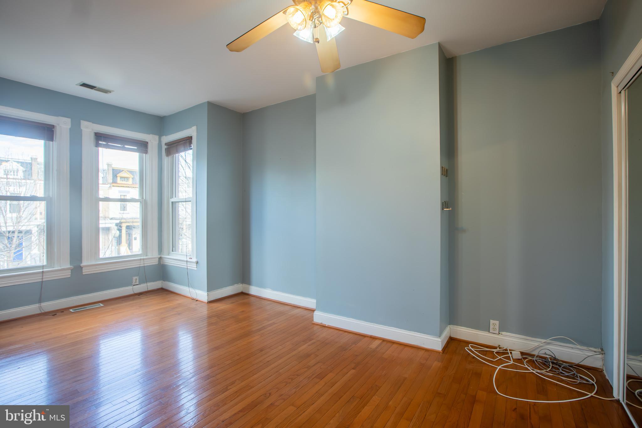 1117 I Street Northeast Washington, DC 20002 - Photo 9 of 23 an empty room with wooden floor and windows