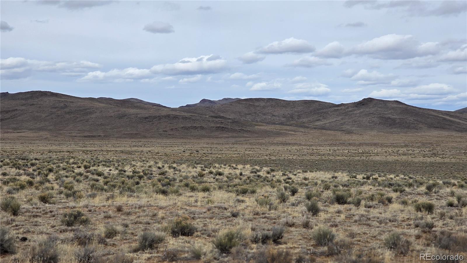 Lot 3 Russ Road Sanford, CO 81151 - Photo 1 of 11 a view of a town with mountains in the background