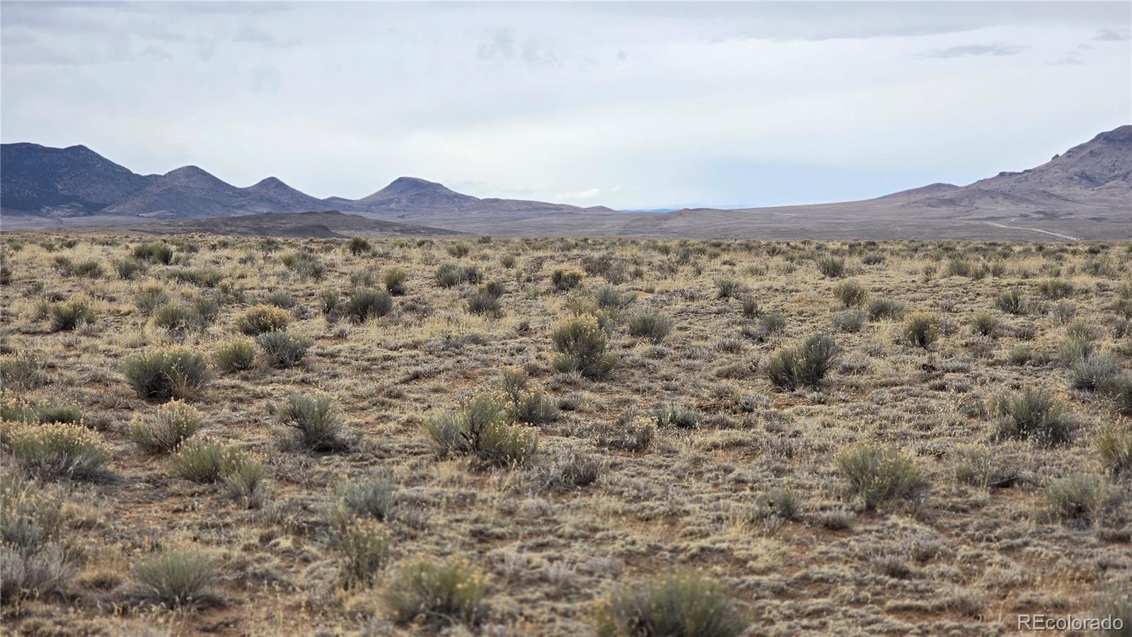 Lot 3 Russ Road Sanford, CO 81151 - Photo 7 of 11 a view of a mountain in the distance in a field