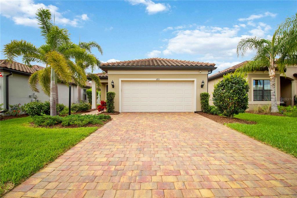 6713 Alstead Circle Lakewood Ranch, FL 34202 - Photo 1 of 35 a front view of house with yard and trees