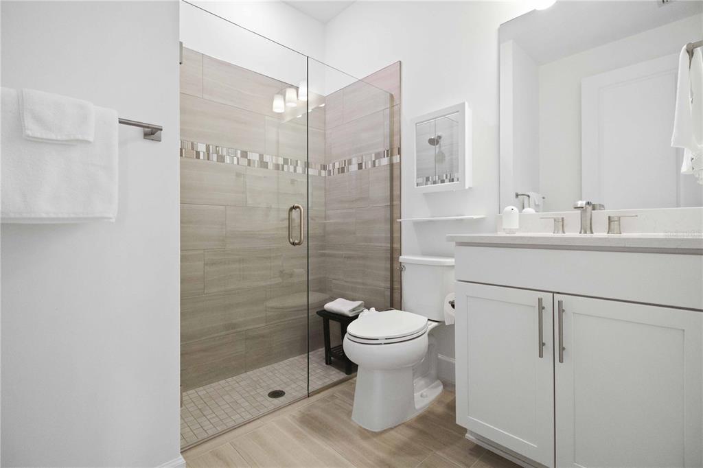 6713 Alstead Circle Lakewood Ranch, FL 34202 - Photo 14 of 35 a bathroom with a sink toilet a mirror and shower