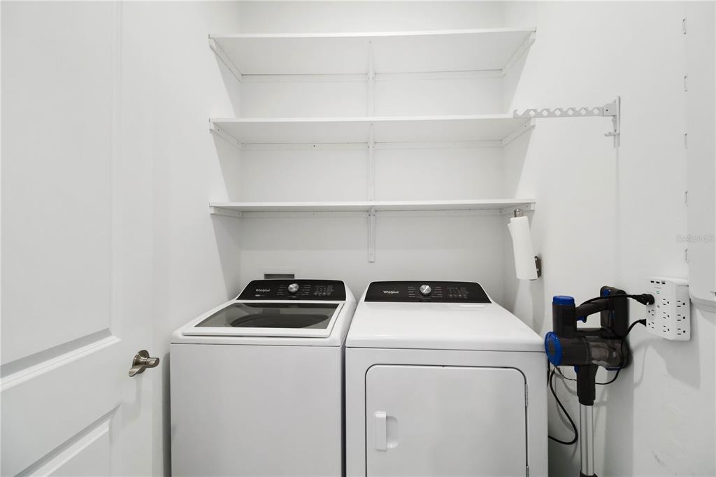 6713 Alstead Circle Lakewood Ranch, FL 34202 - Photo 15 of 35 a view of storage and utility room with washer and dryer