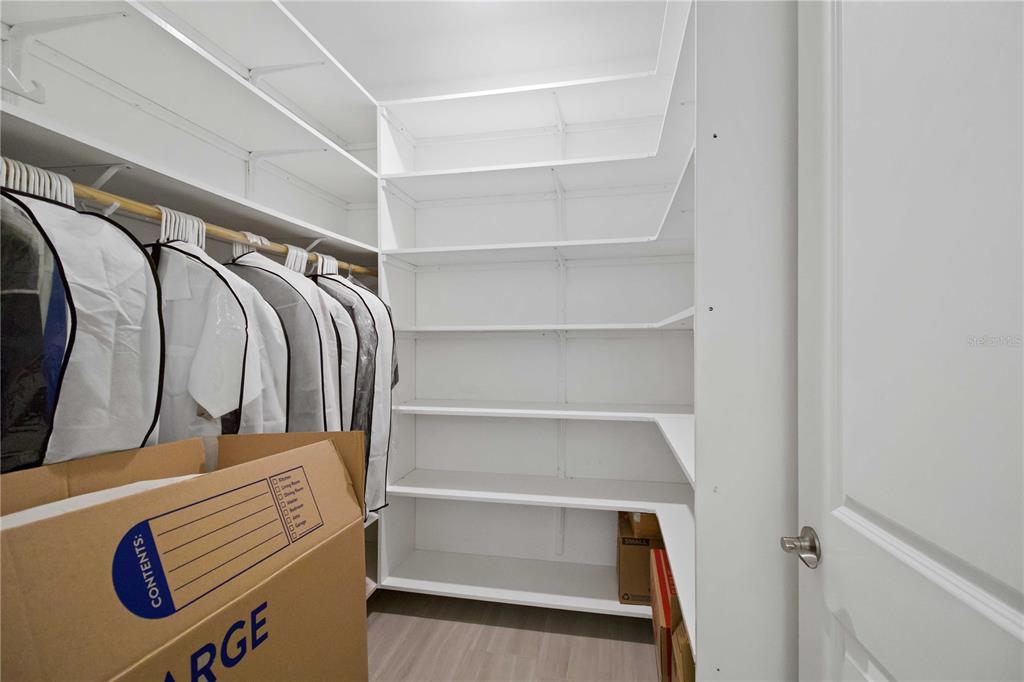 6713 Alstead Circle Lakewood Ranch, FL 34202 - Photo 20 of 35 a view of walk in closet with clothes and shoes