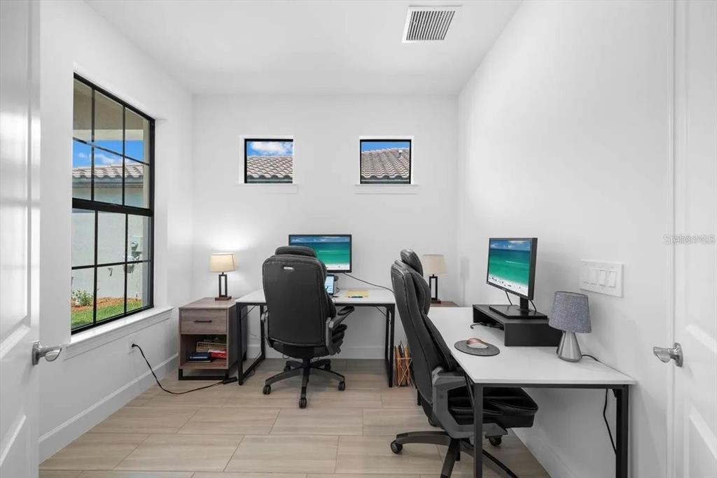 6713 Alstead Circle Lakewood Ranch, FL 34202 - Photo 23 of 35 a view of a workspace with furniture and a window