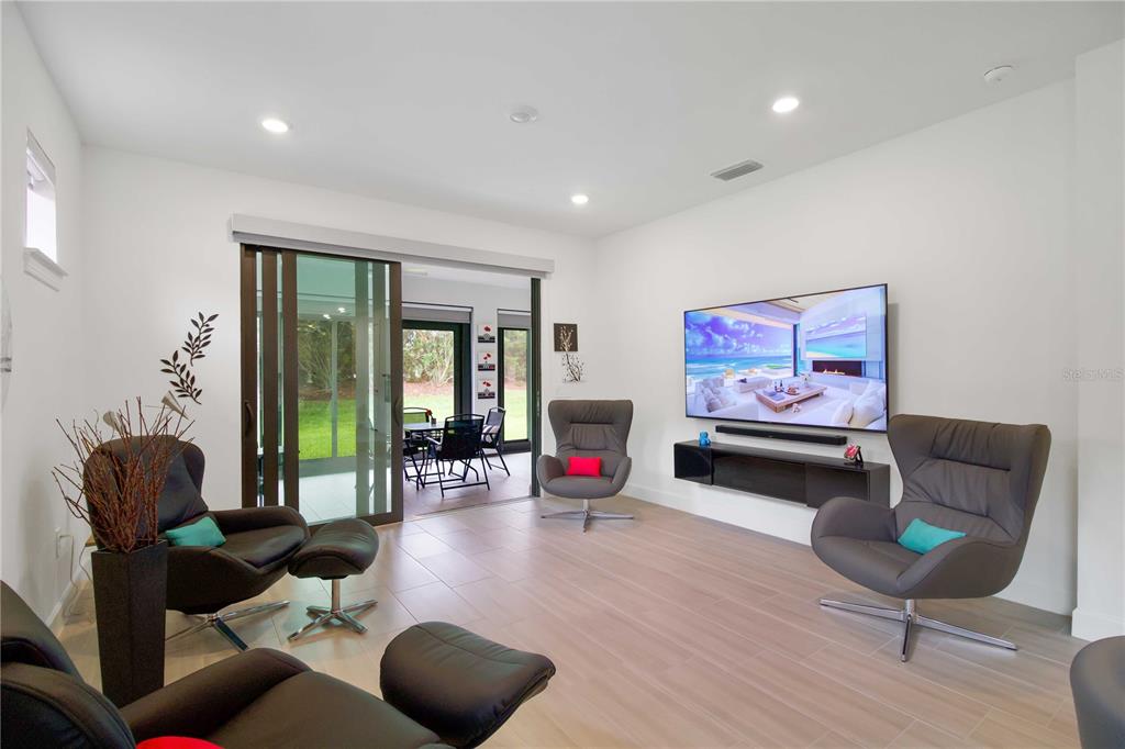 6713 Alstead Circle Lakewood Ranch, FL 34202 - Photo 10 of 35 a living room with furniture and a wooden floor