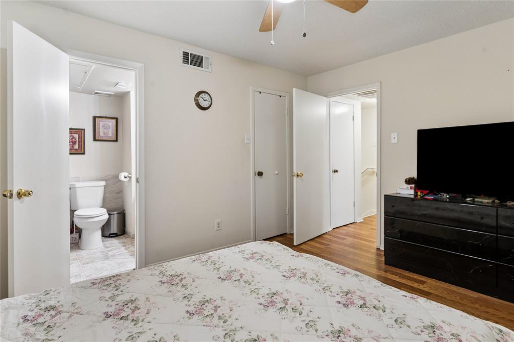 11311 Audelia Road, Unit 102 Dallas, TX 75243 - Photo 21 of 31 Wood-finish flooring with white interior doors, a ceiling fan, and a light-colored wall finish