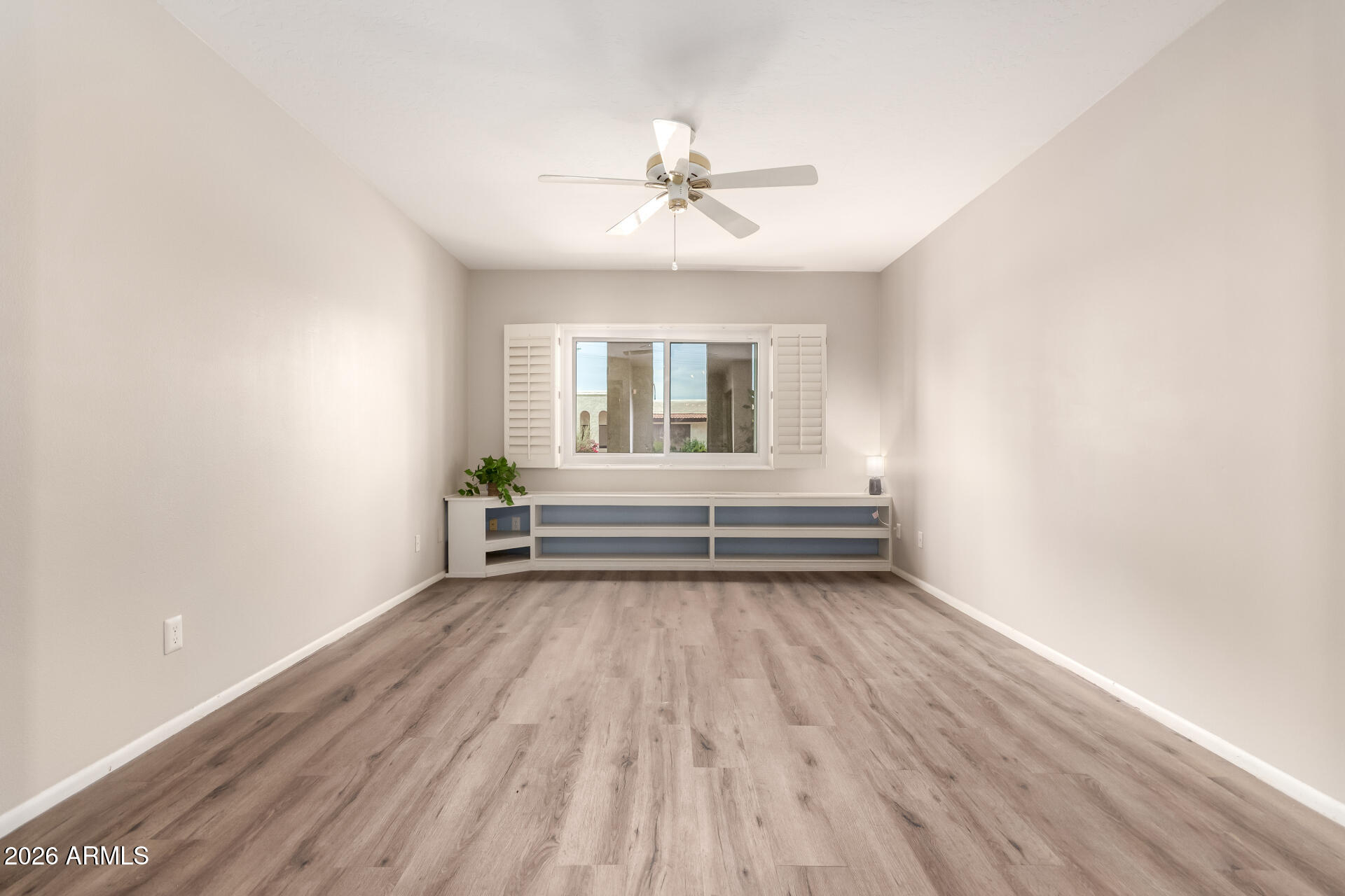 1833 West Citrus Way Phoenix, AZ 85015 - Photo 14 of 36 a view of a livingroom with wooden floor and a ceiling fan