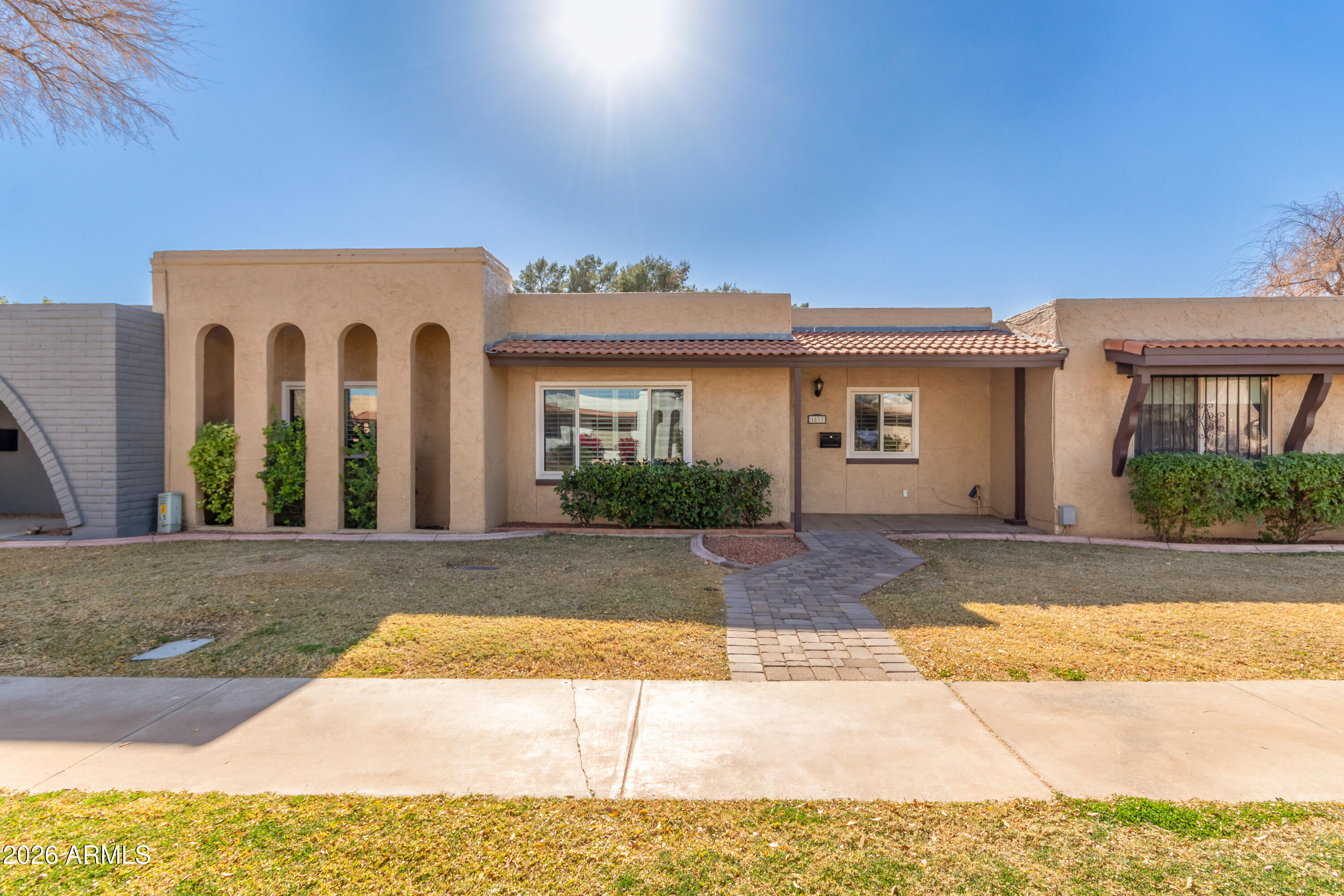 1833 West Citrus Way Phoenix, AZ 85015 - Photo 2 of 36 a view of a brick house with many windows