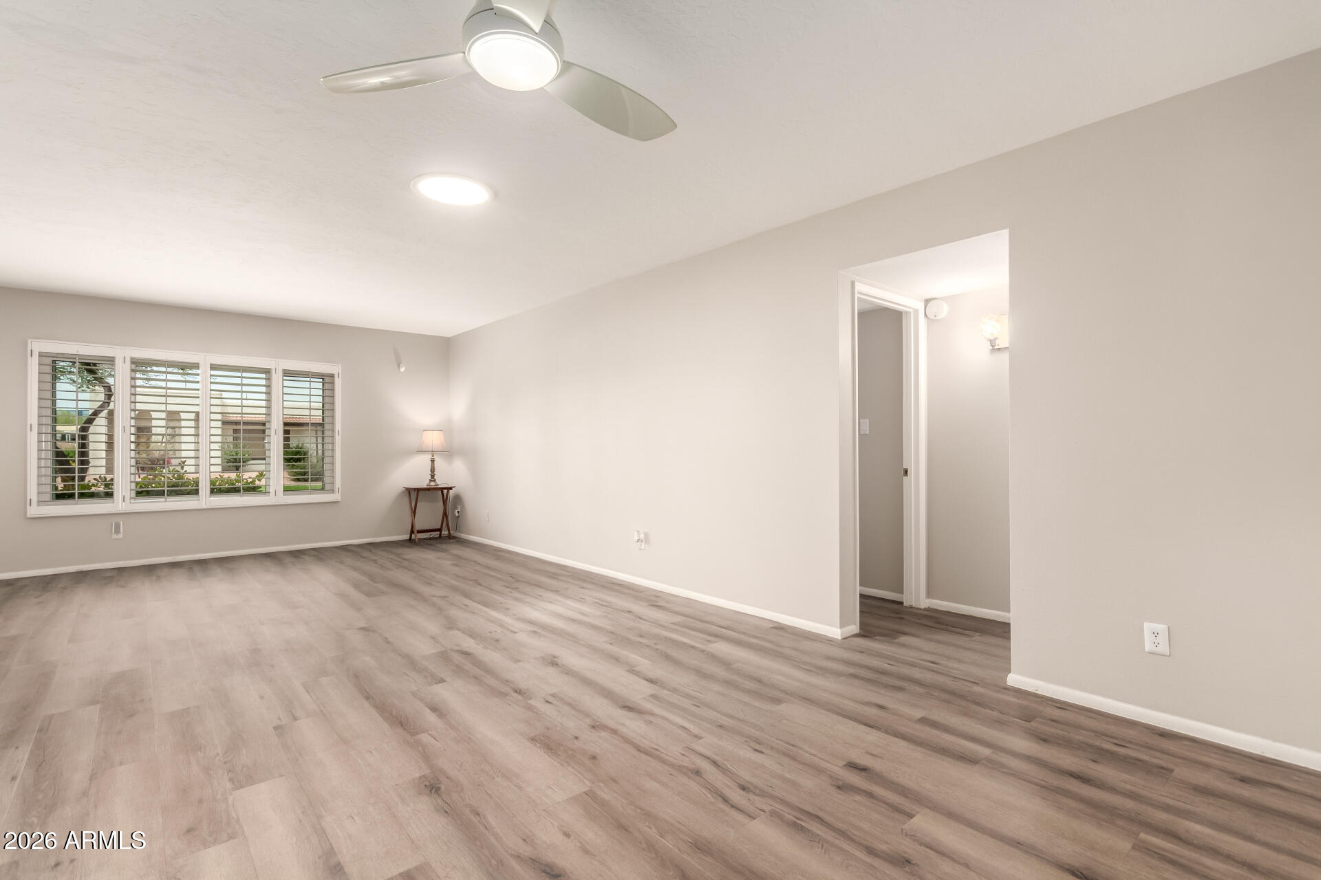 1833 West Citrus Way Phoenix, AZ 85015 - Photo 5 of 36 an empty room with wooden floor and windows