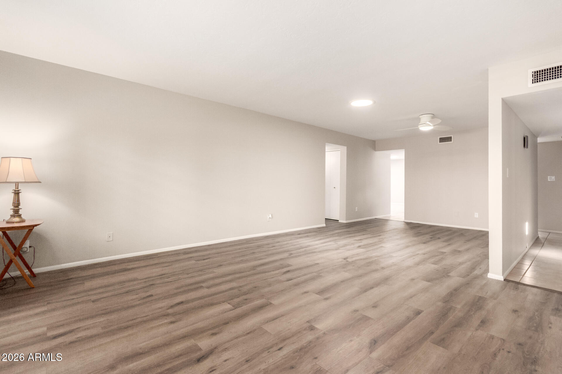 1833 West Citrus Way Phoenix, AZ 85015 - Photo 6 of 36 a view of an empty room with wooden floor