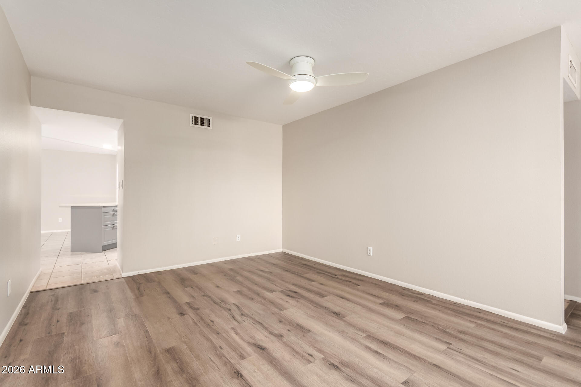 1833 West Citrus Way Phoenix, AZ 85015 - Photo 7 of 36 a view of an empty room with wooden floor