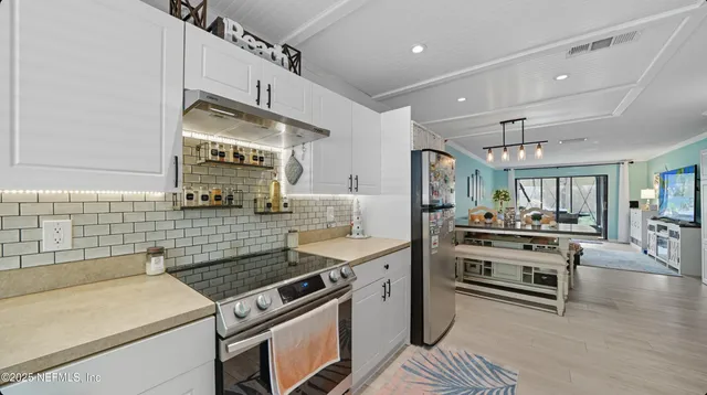 a living room with furniture and a floor to ceiling window