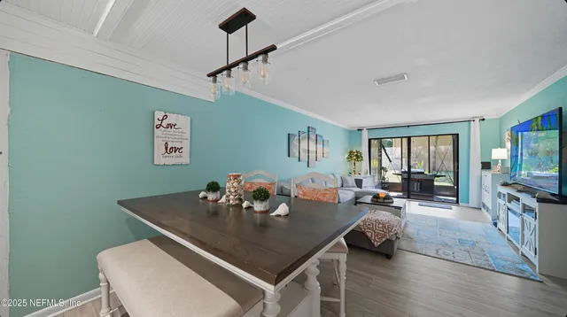 a living room with furniture and a kitchen
