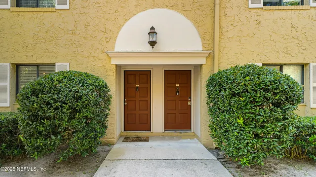 a view of entryway with a workspace and bedroom