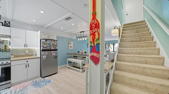 a view of a kitchen with stove and cabinets