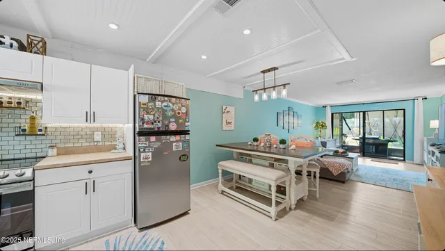 a living room with furniture a flat screen tv and a table