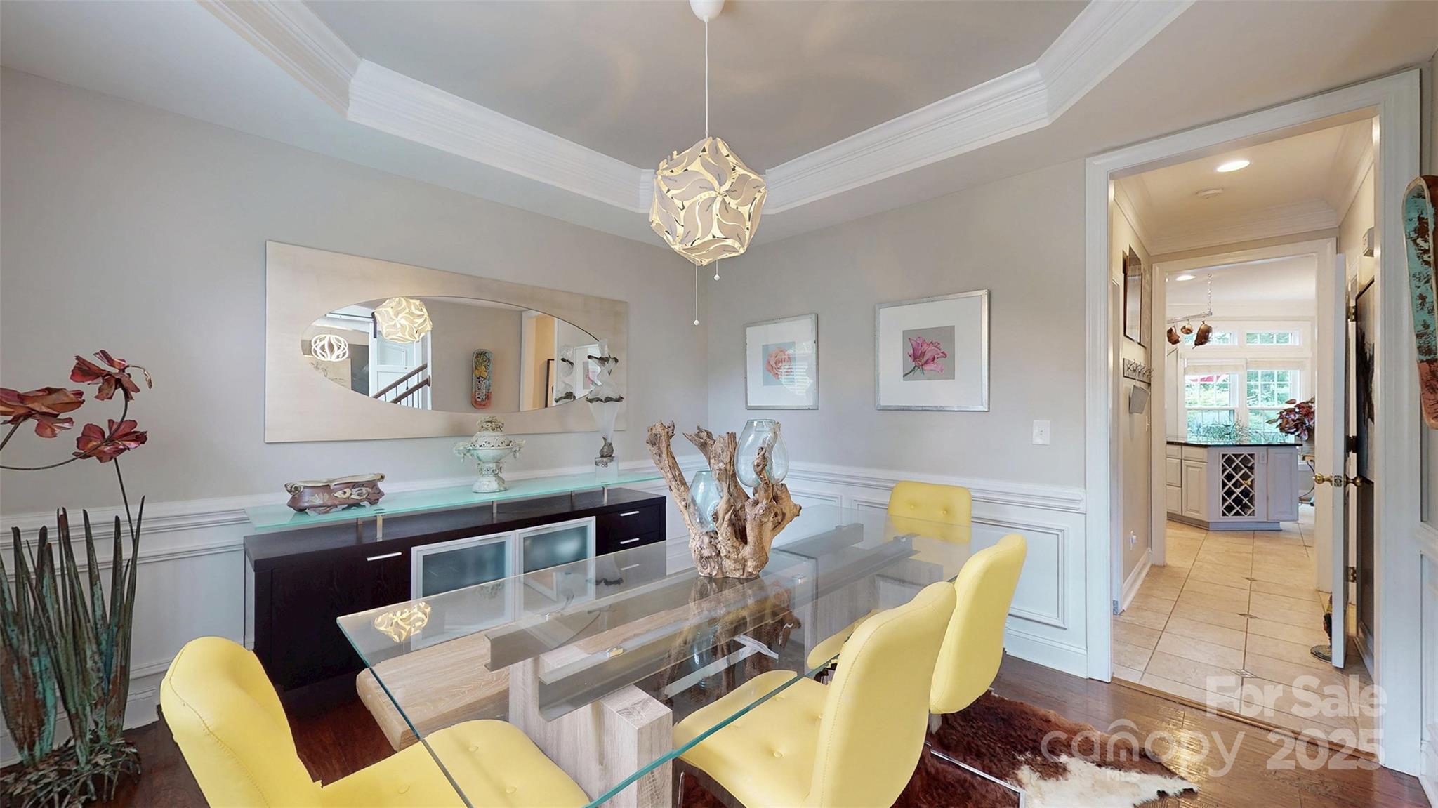 9014 Cardinal Ridge Court Charlotte, NC 28270 - Photo 18 of 45 a view of a dining room with furniture a chandelier and wooden floor