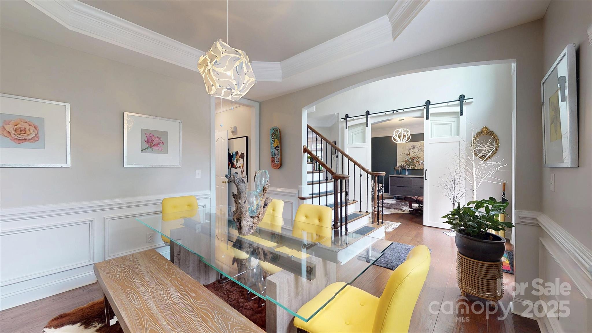 9014 Cardinal Ridge Court Charlotte, NC 28270 - Photo 19 of 45 a view of a dining room with furniture a chandelier and wooden floor
