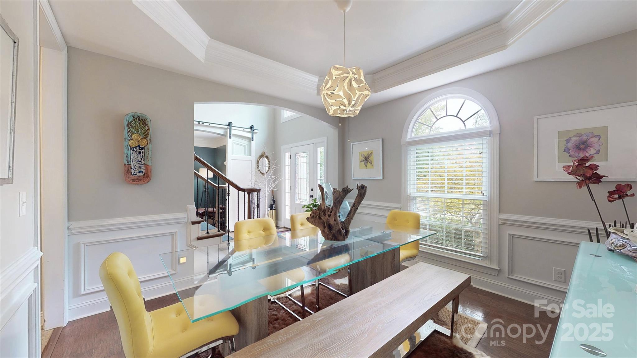 9014 Cardinal Ridge Court Charlotte, NC 28270 - Photo 20 of 45 a view of a dining room with furniture a chandelier and wooden floor
