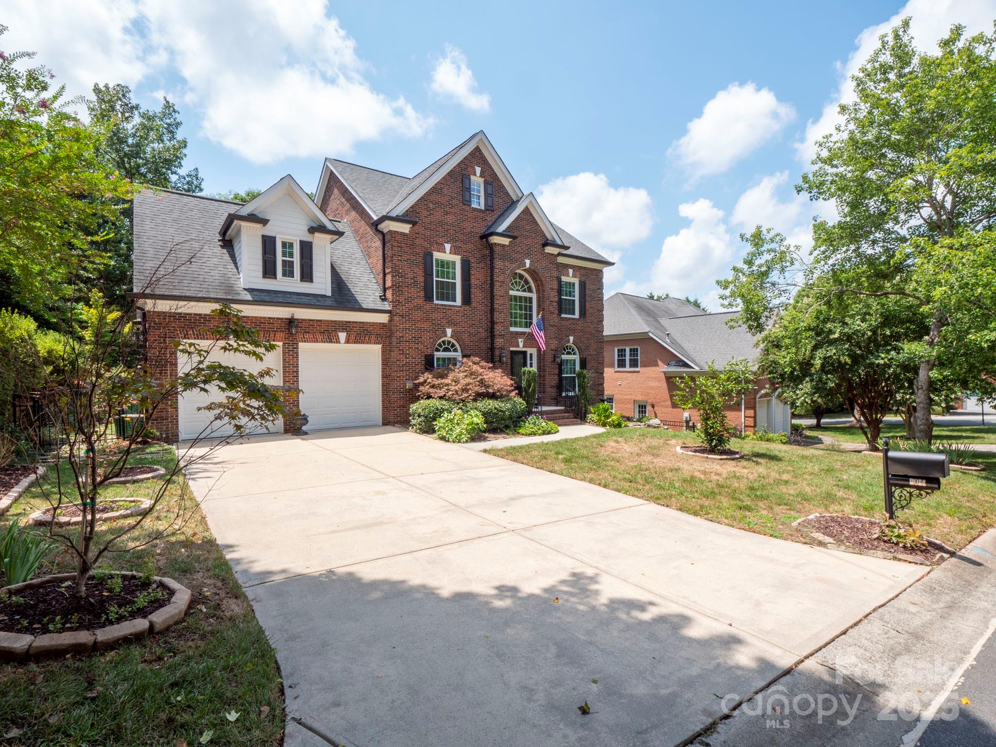 9014 Cardinal Ridge Court Charlotte, NC 28270 - Photo 2 of 45 a front view of a house with a yard