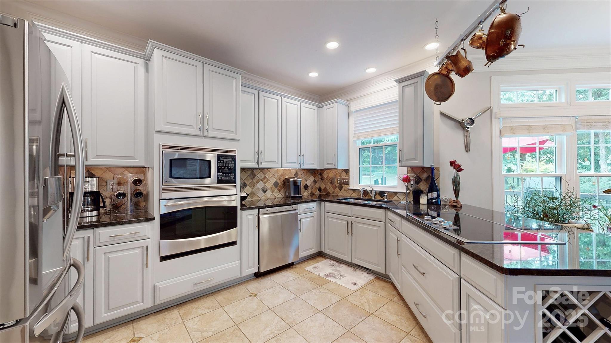 9014 Cardinal Ridge Court Charlotte, NC 28270 - Photo 22 of 45 a kitchen with white cabinets and white appliances