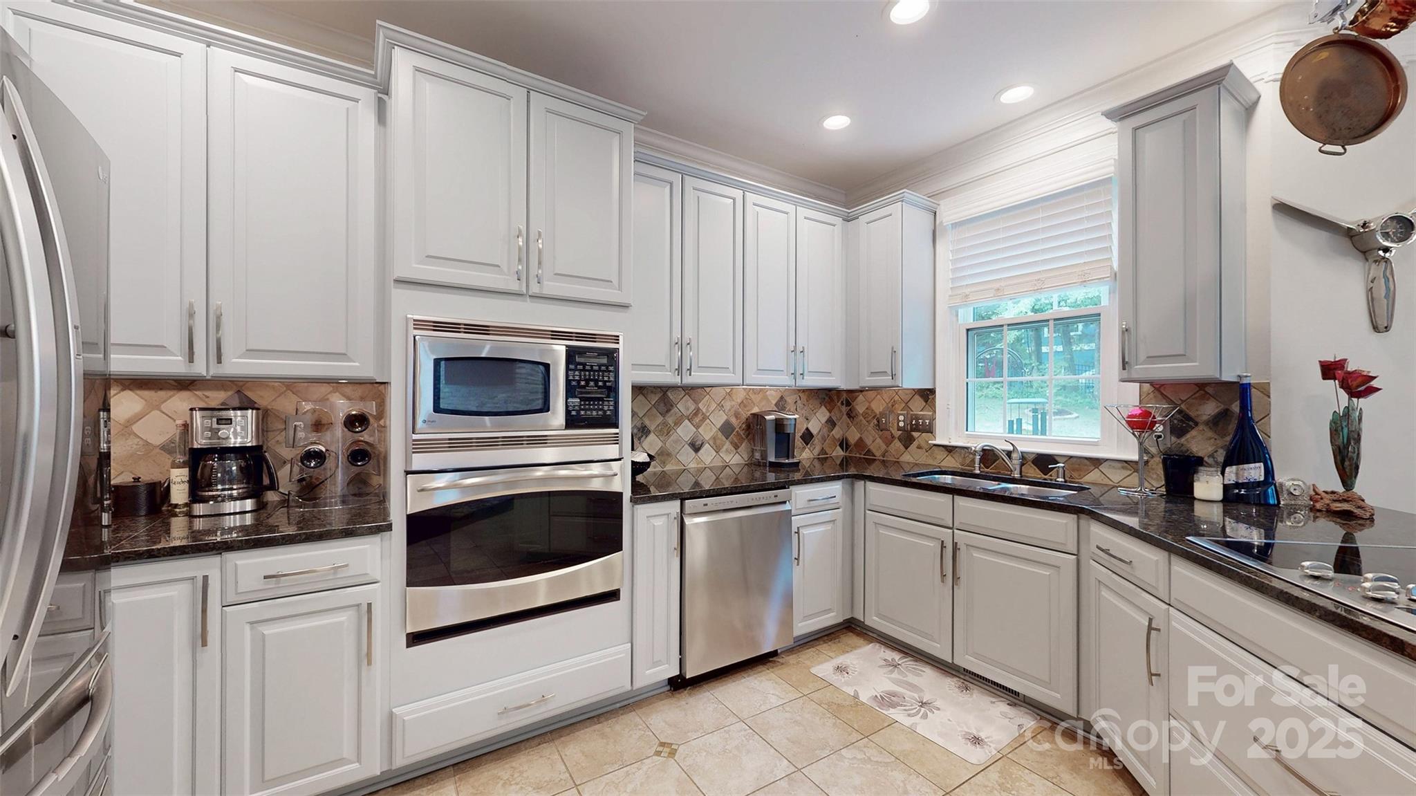 9014 Cardinal Ridge Court Charlotte, NC 28270 - Photo 25 of 45 a kitchen with white cabinets and white appliances