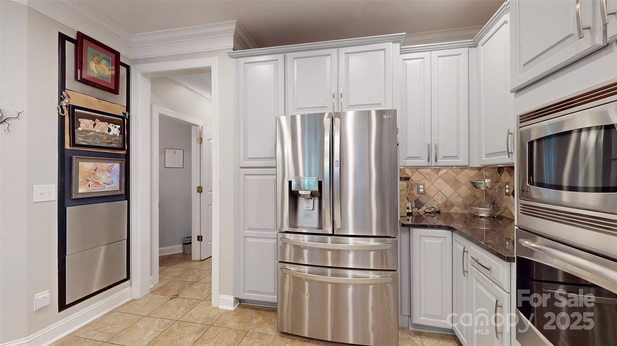 9014 Cardinal Ridge Court Charlotte, NC 28270 - Photo 27 of 45 a metallic refrigerator freezer and a stove sitting inside of a kitchen