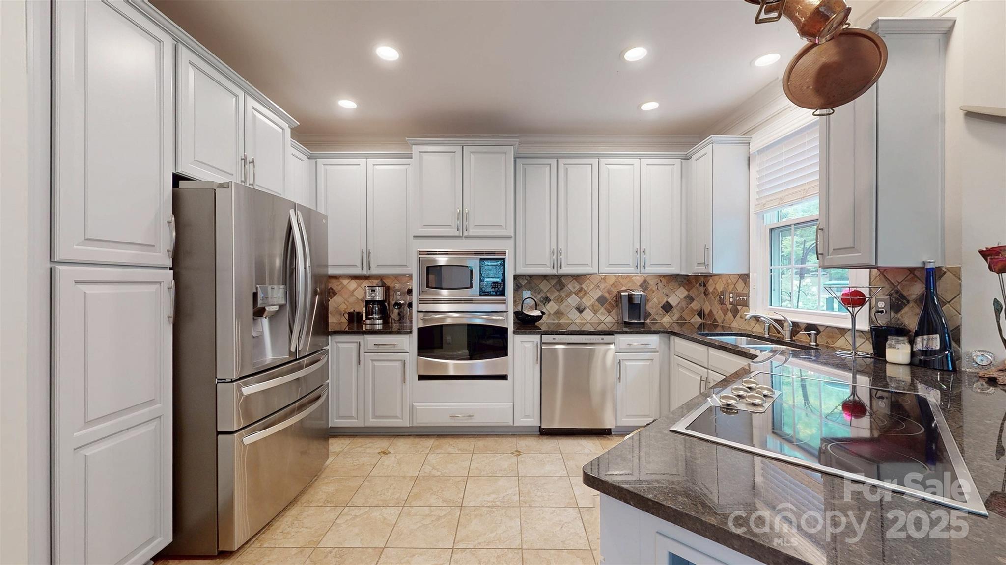 9014 Cardinal Ridge Court Charlotte, NC 28270 - Photo 30 of 45 a kitchen with stainless steel appliances granite countertop a refrigerator sink and stove