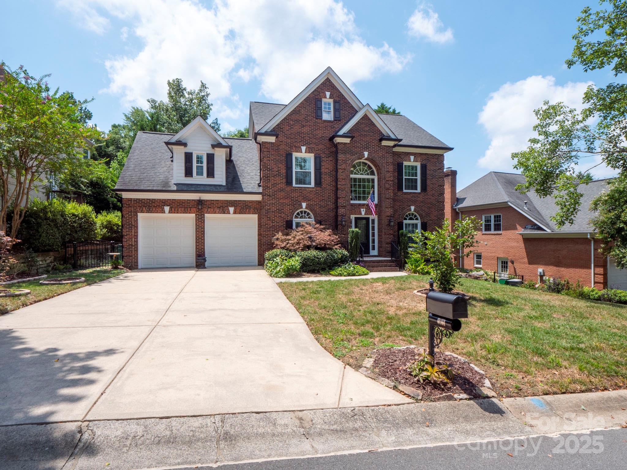 9014 Cardinal Ridge Court Charlotte, NC 28270 - Photo 3 of 45 a front view of a house with a yard and garage