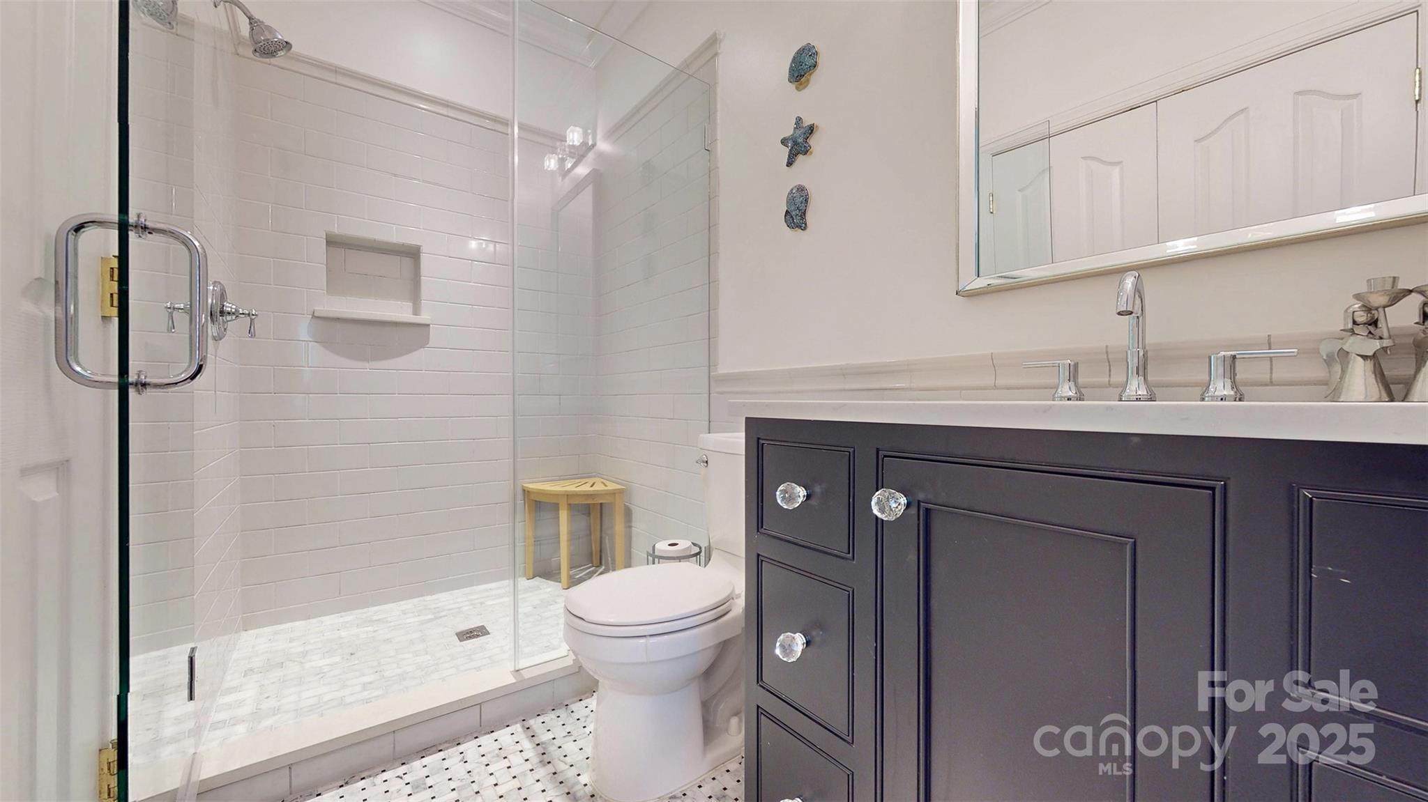 9014 Cardinal Ridge Court Charlotte, NC 28270 - Photo 38 of 45 a bathroom with a sink a toilet and shower