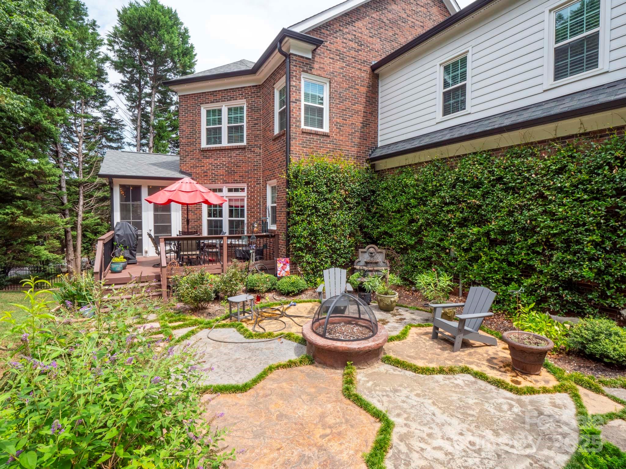 9014 Cardinal Ridge Court Charlotte, NC 28270 - Photo 5 of 45 a view of a patio with table and chairs and potted plants