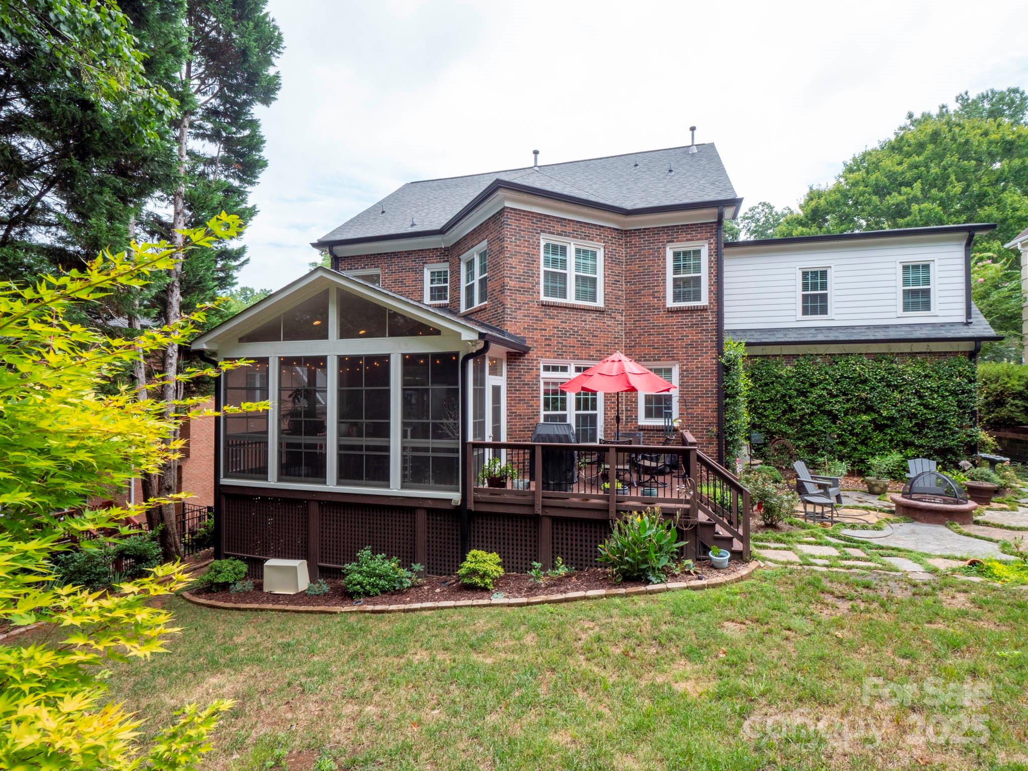 9014 Cardinal Ridge Court Charlotte, NC 28270 - Photo 8 of 45 a front view of a house with a yard and potted plants