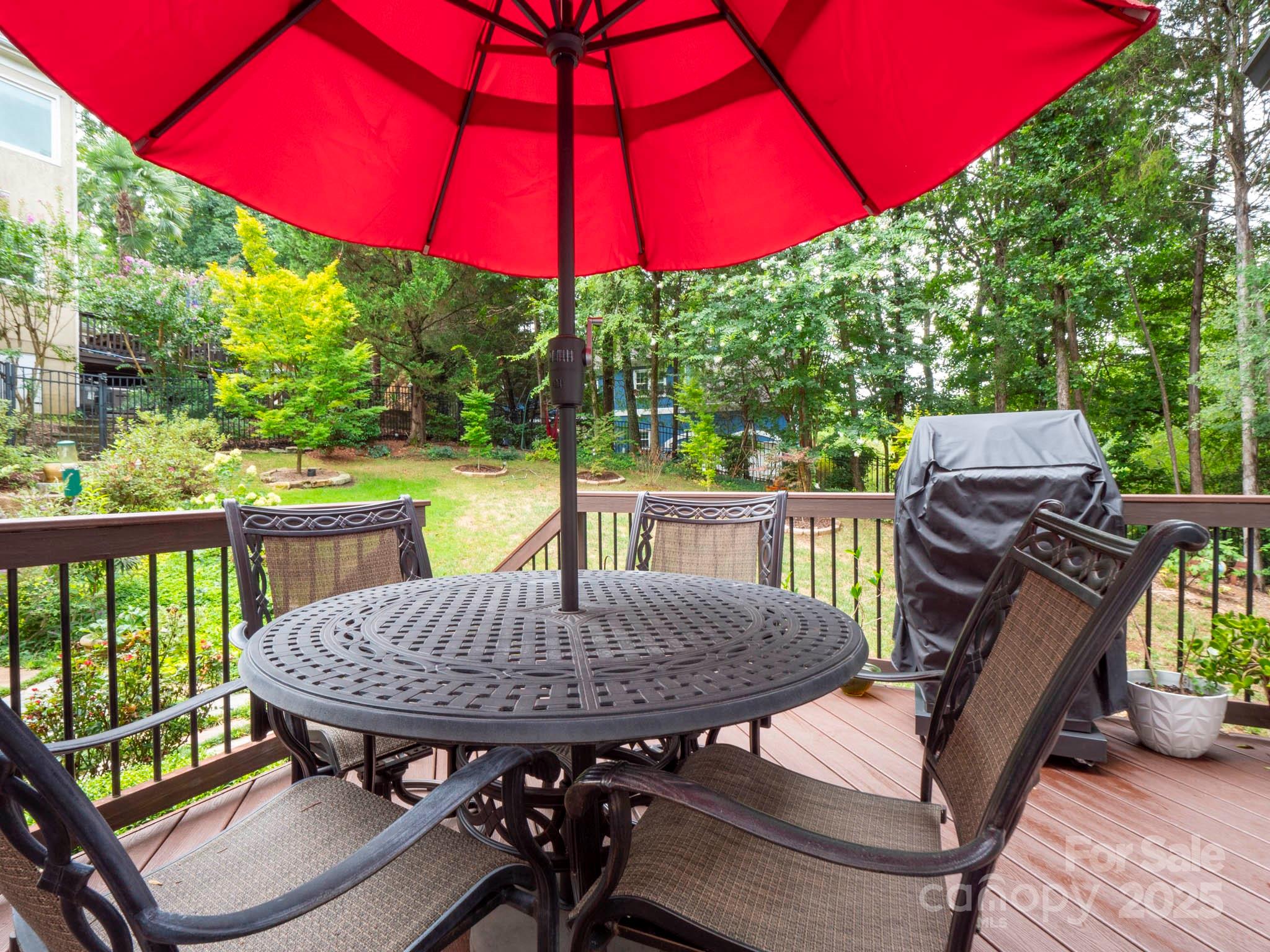 9014 Cardinal Ridge Court Charlotte, NC 28270 - Photo 9 of 45 a view of a patio with a table chairs and a umbrella