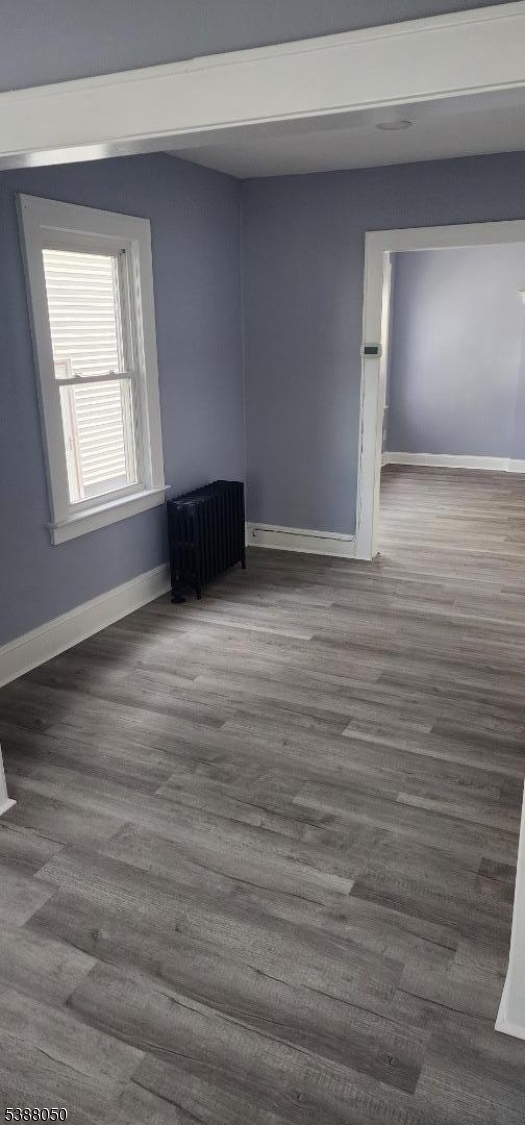 530 Drake Avenue Roselle, NJ 07203 - Photo 3 of 19 a view of an empty room with wooden floor and a window