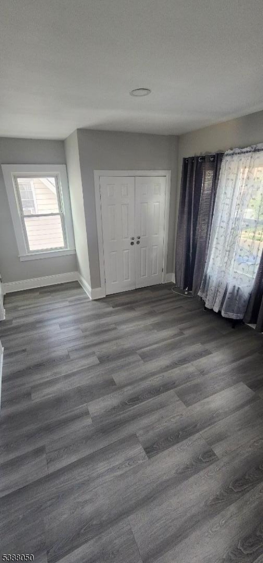 530 Drake Avenue Roselle, NJ 07203 - Photo 8 of 19 an empty room with wooden floor and windows